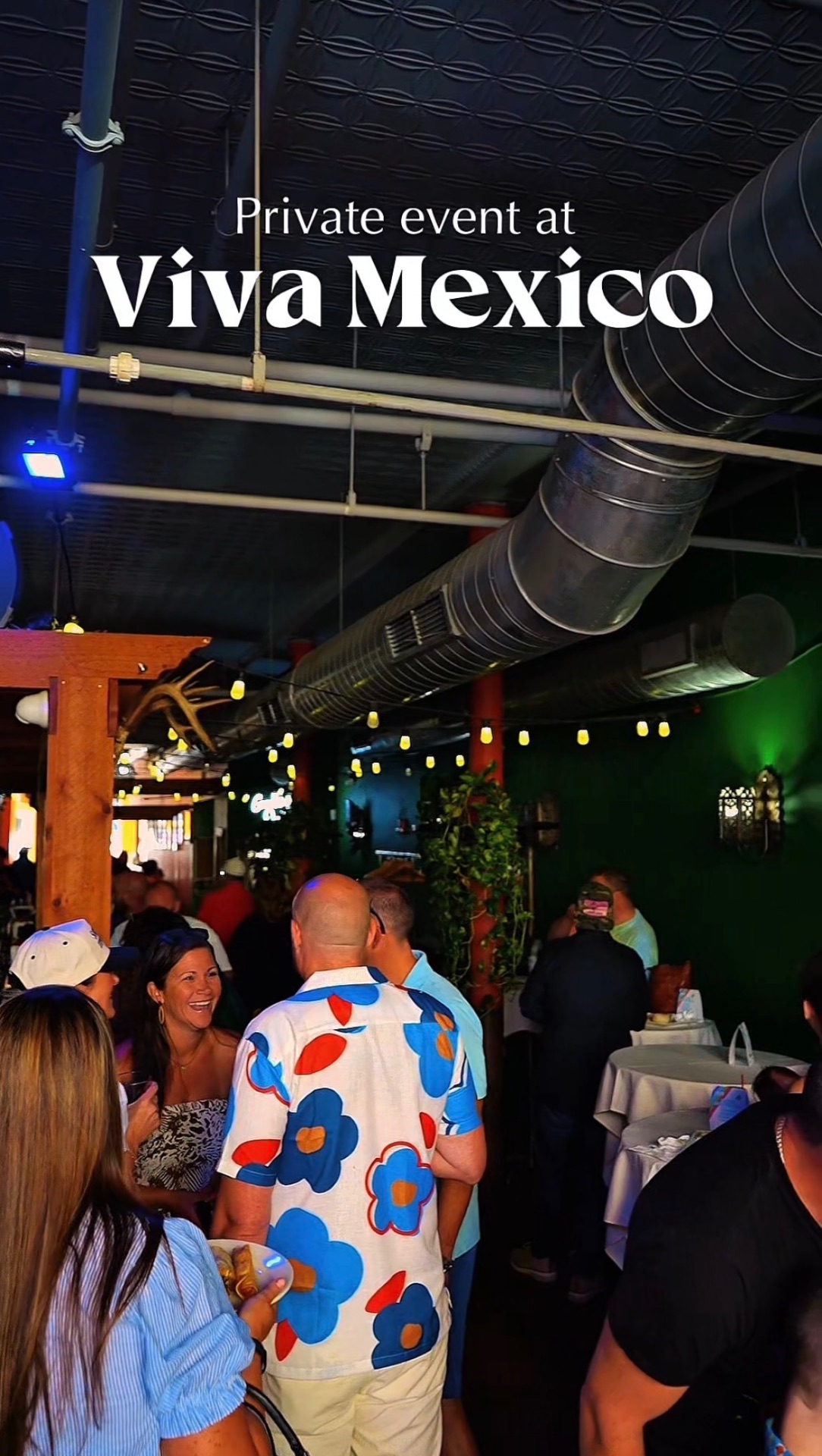 A lively private event in the Back Room at Viva Mexico Cantina & Grill — guests mingling under string lights